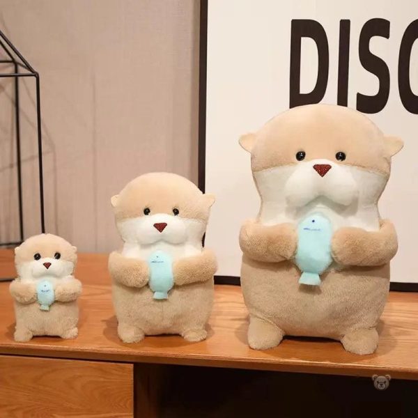 Peluche douce représentant une loutre et son poisson