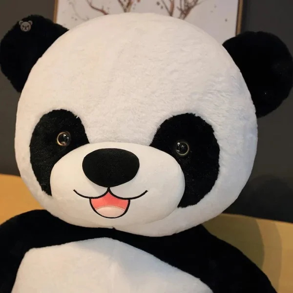 le-gros-panda-peluche-panda-1 Peluche panda géant avec une fleur colorée