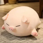 Peluche cochon allongé aux yeux fermés