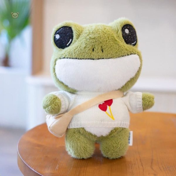 Grenouille en peluche douce, vêtue d'un pull d'hiver
