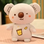 Peluche mignonne de koala dégustant une boisson fruitée