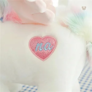 Peluche licorne aux ailes dorées