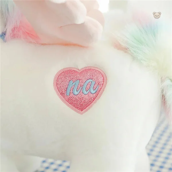 Peluche licorne aux ailes dorées