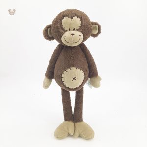 Peluche singe curieuse et attachante