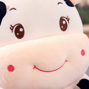 Jouet en peluche vache bébé, visage souriant