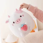 Vache en peluche colorée, rose et blanche, idéale pour les enfants